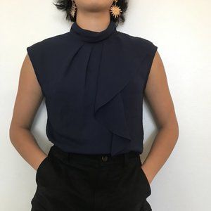 Elegant sleeveless blouse with asymmetrical ruffle